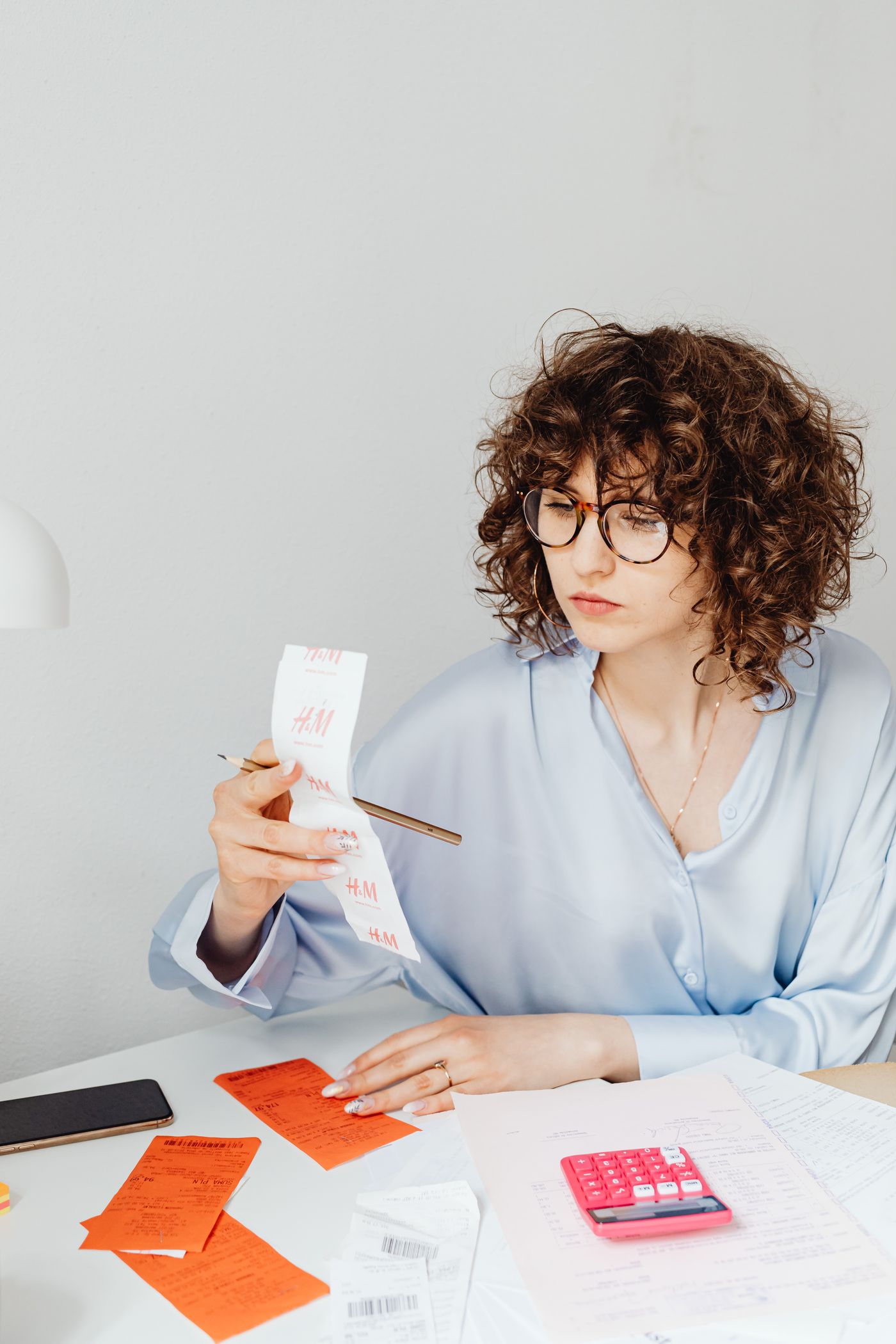 Person reviewing a receipt at a desk.