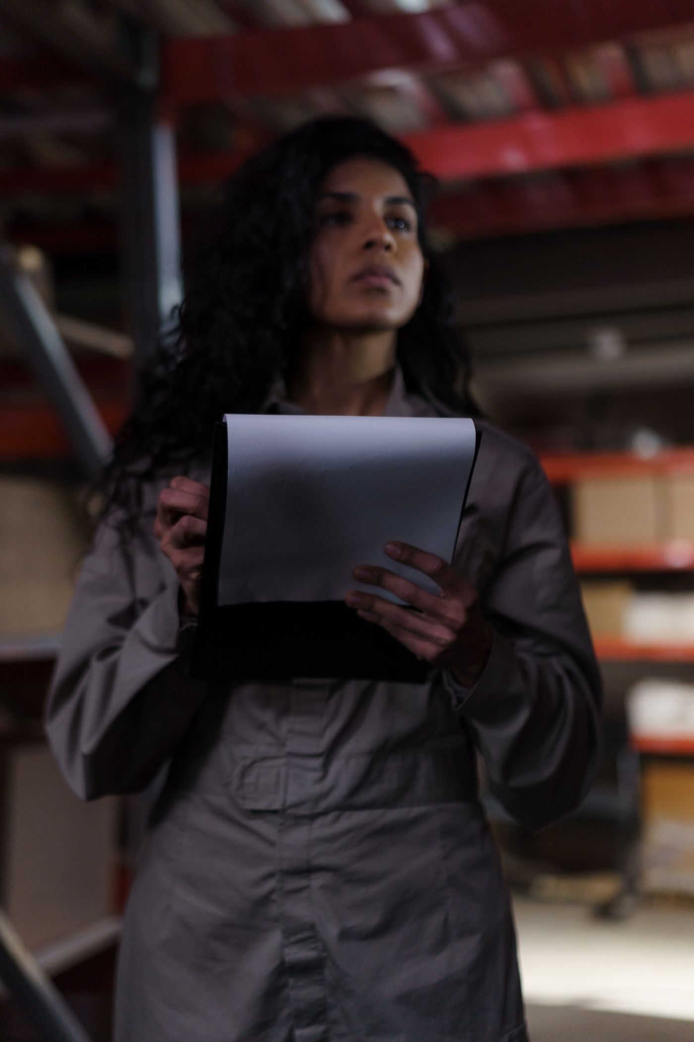 Mechanic holding a clipboard in a workshop.
